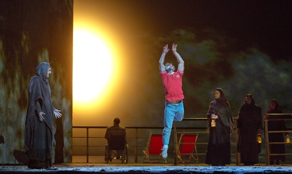 Young Omar (dancer Jesse Kovarsky) is inspired to seek a martyr's Paradise. Metropolitan Opera 2014. (Ken Howard)