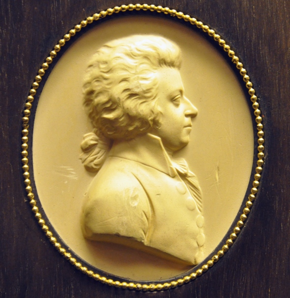 Mozart by Leonard Posch, 1788-89, detail from plaster relief of wood carving (Wien Kunsthistorisches Museum via Wiki Commons)