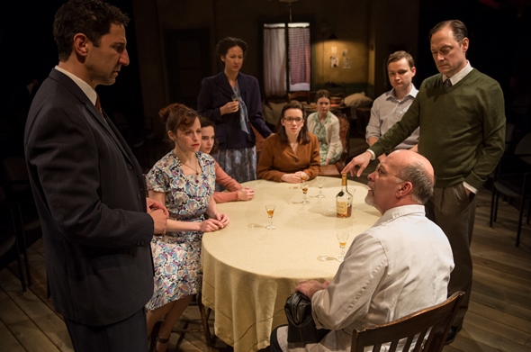 The dining table is the gathering place for Mr. van Daan (Lance Baker, standing far right) and other Jewish fugitives in 'The Diary of Anne Frank.' (Michael Brosilow)