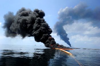 U.S. Coast Guard and BP set a fire to attempt control of spreading oil after the April 2010 explosion of the BP Horizon. (Defense.gov)