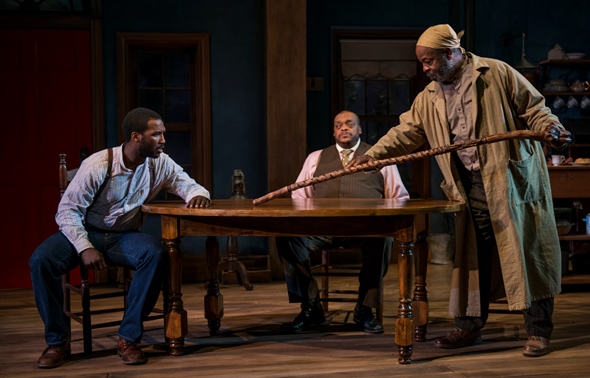 Solly Two Kings (Alfred H. Wilson) tells Citizen (Jerod Haynes) about his walking stick as Eli (A.C. Smith) looks on. (Michael Brosilow)