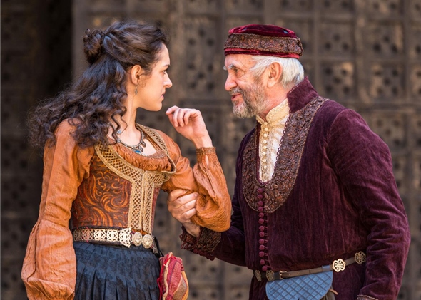 Shylock (Jonathan Pryce) cautions his daughter Jessica (Phoebe Pryce) to stay within their house. (Marc Brenner)