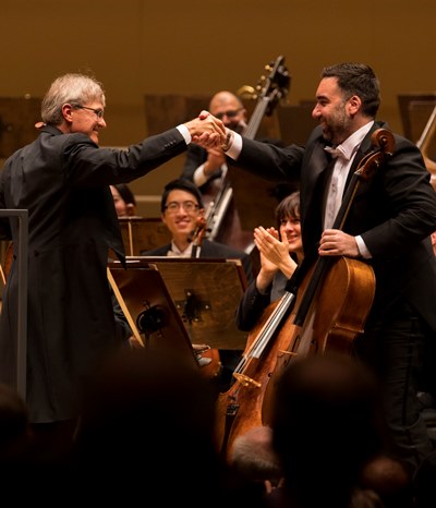 Principal cello John Sharp, left, exchanges compliments with assistant principal Kenneth Olsen. (Todd Rosenberg)